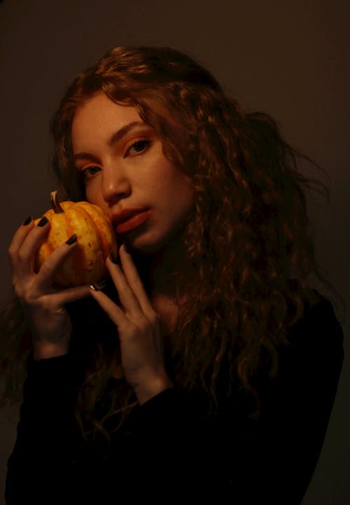 Woman Holding Fruit and Posing