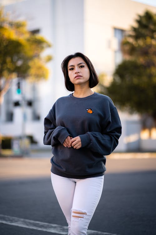 Woman in Sweater and Pants in City