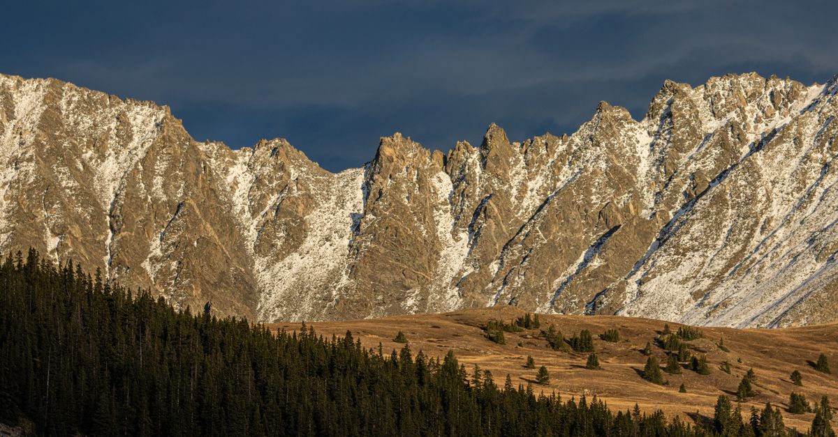 Captivating view of the snow-dusted mountains in Leadville, Colorado under a dramatic sky.