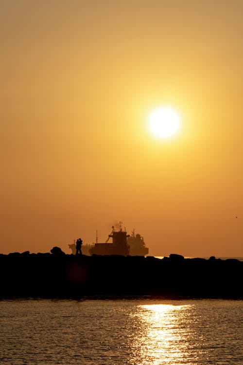 Sun on Clear Sky over Ship at Sunset