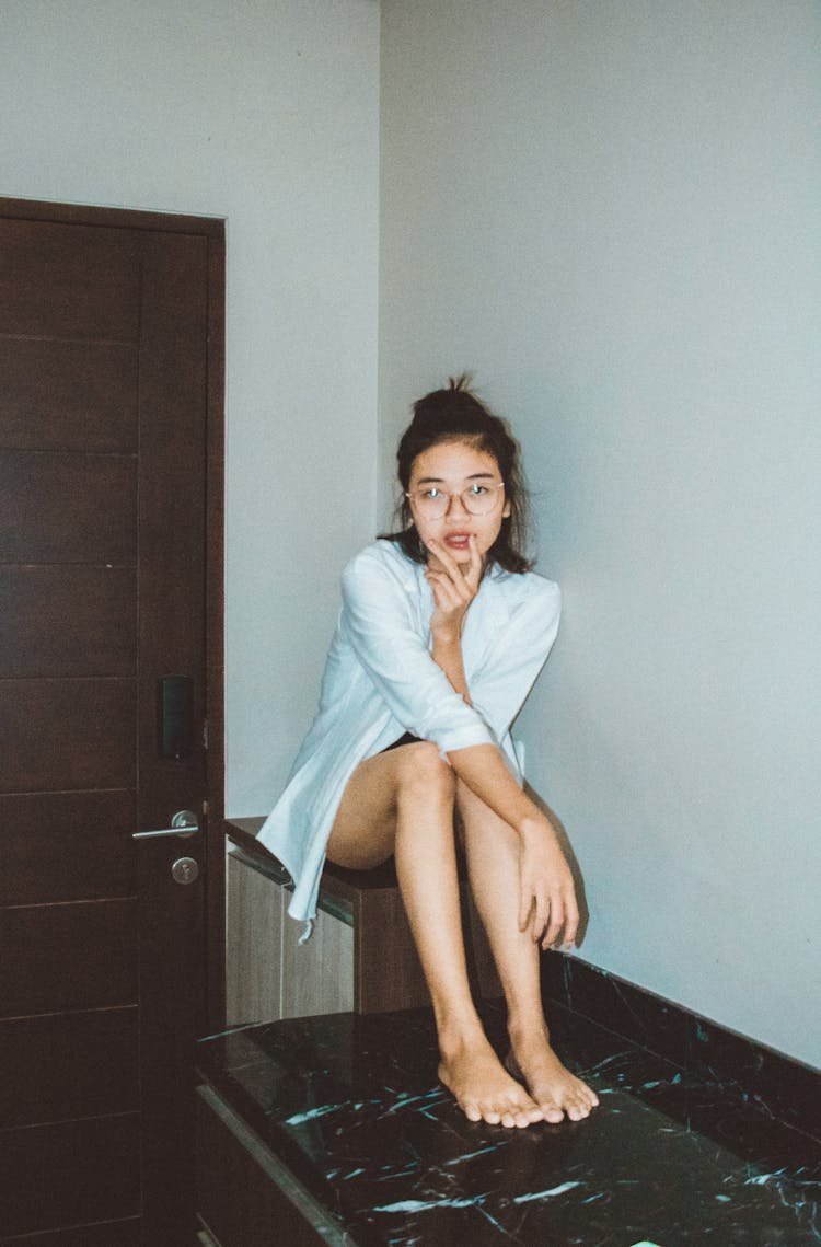 Young Woman Sitting On Table