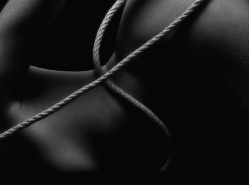 Monochrome Photo of Rope On Body
