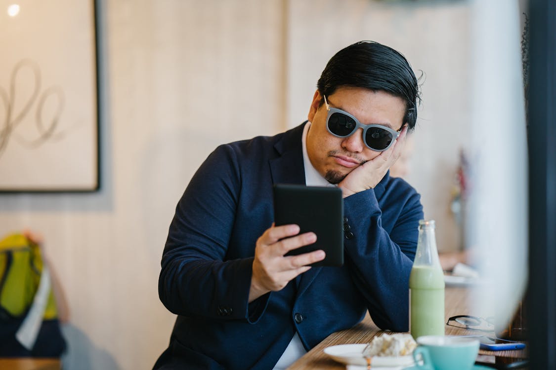 Free Man Wearing Grey Sunglasses Holding Black Tablet  Stock Photo