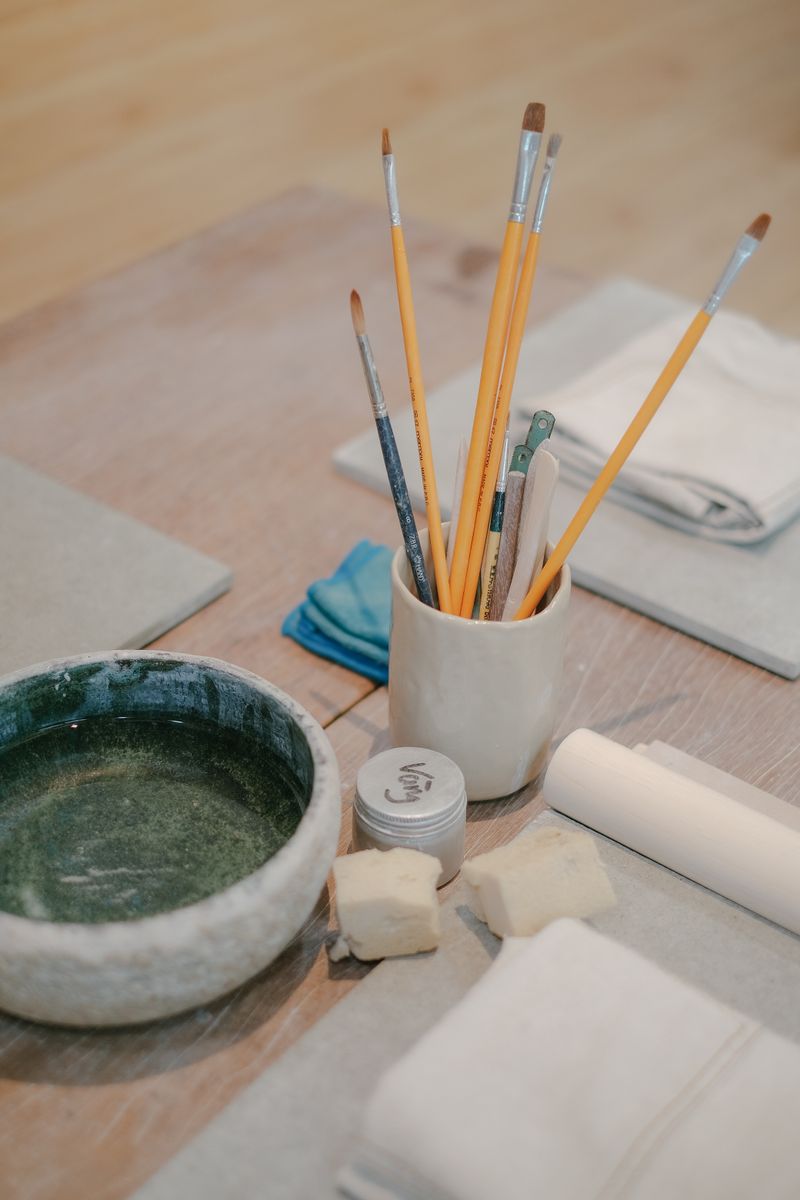 Paintbrushes and art tools on a workspace