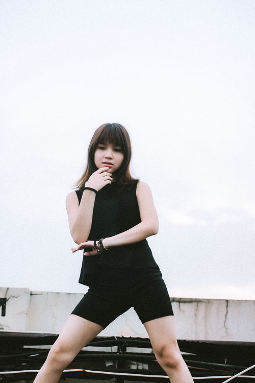 Free Portrait of a young woman standing outdoors, showcasing fashion and style. Stock Photo