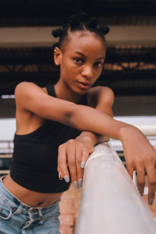 Close Up Photo of Woman Leaning on Railing