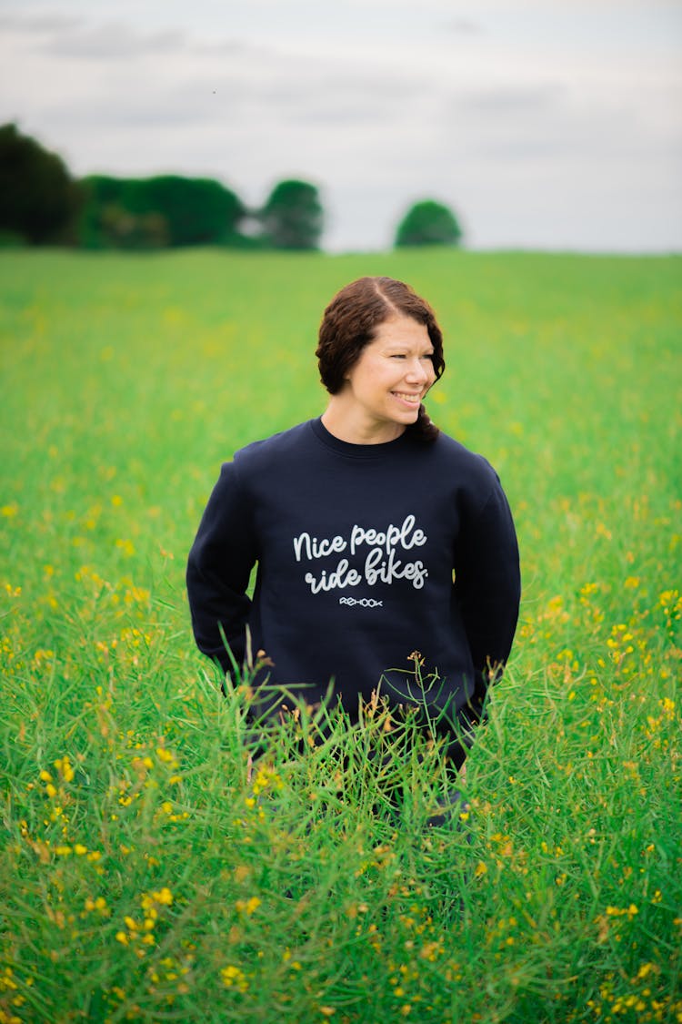 Woman Wearing Sweatshirt Walking In Flower Field