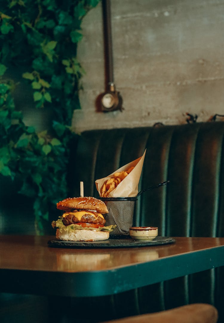 Burger And Fries On Restaurant Table