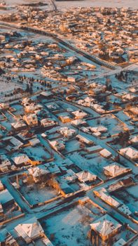 Aerial shot of Sarayönü, Konya showcasing snow-covered roofs during winter.