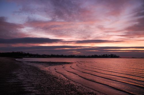 Free Beautiful tranquil sunset over a serene beach in Stamford, Connecticut, USA. Stock Photo