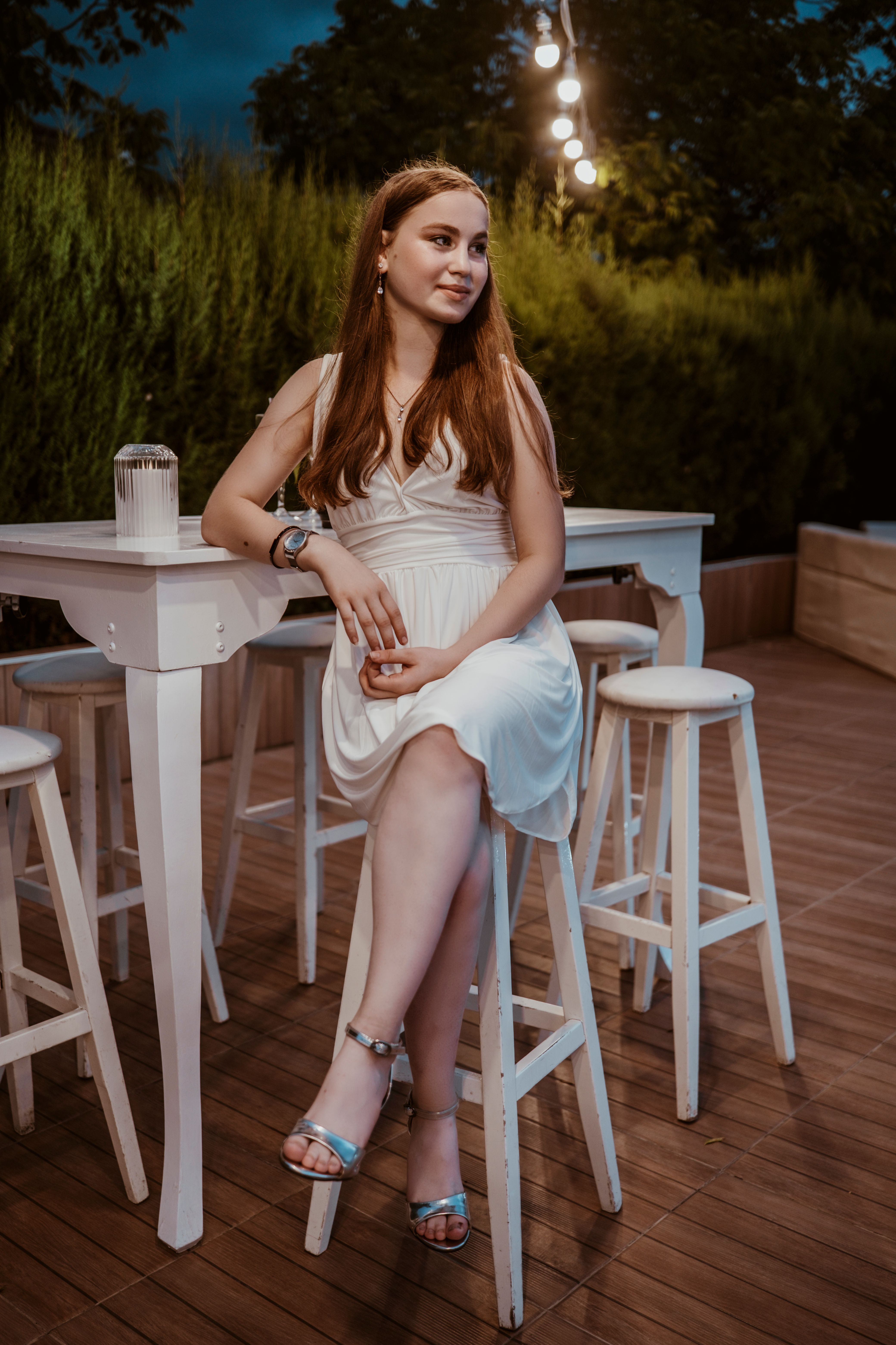 Woman in White Long Sleeves and Vest Sitting on a Chair · Free Stock Photo