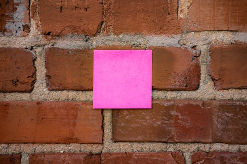 Sticky Note on Red Brick Wall