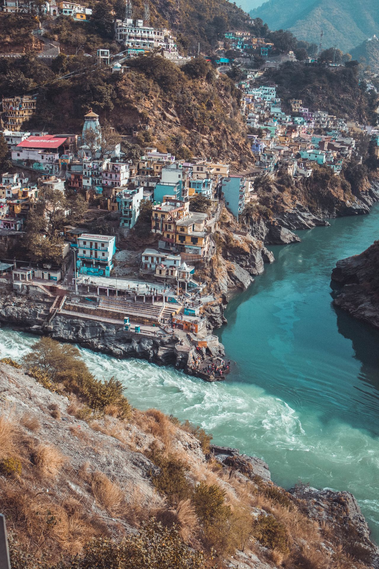 Colourful buildings on the rocky hills above the Ganga at Rishikesh