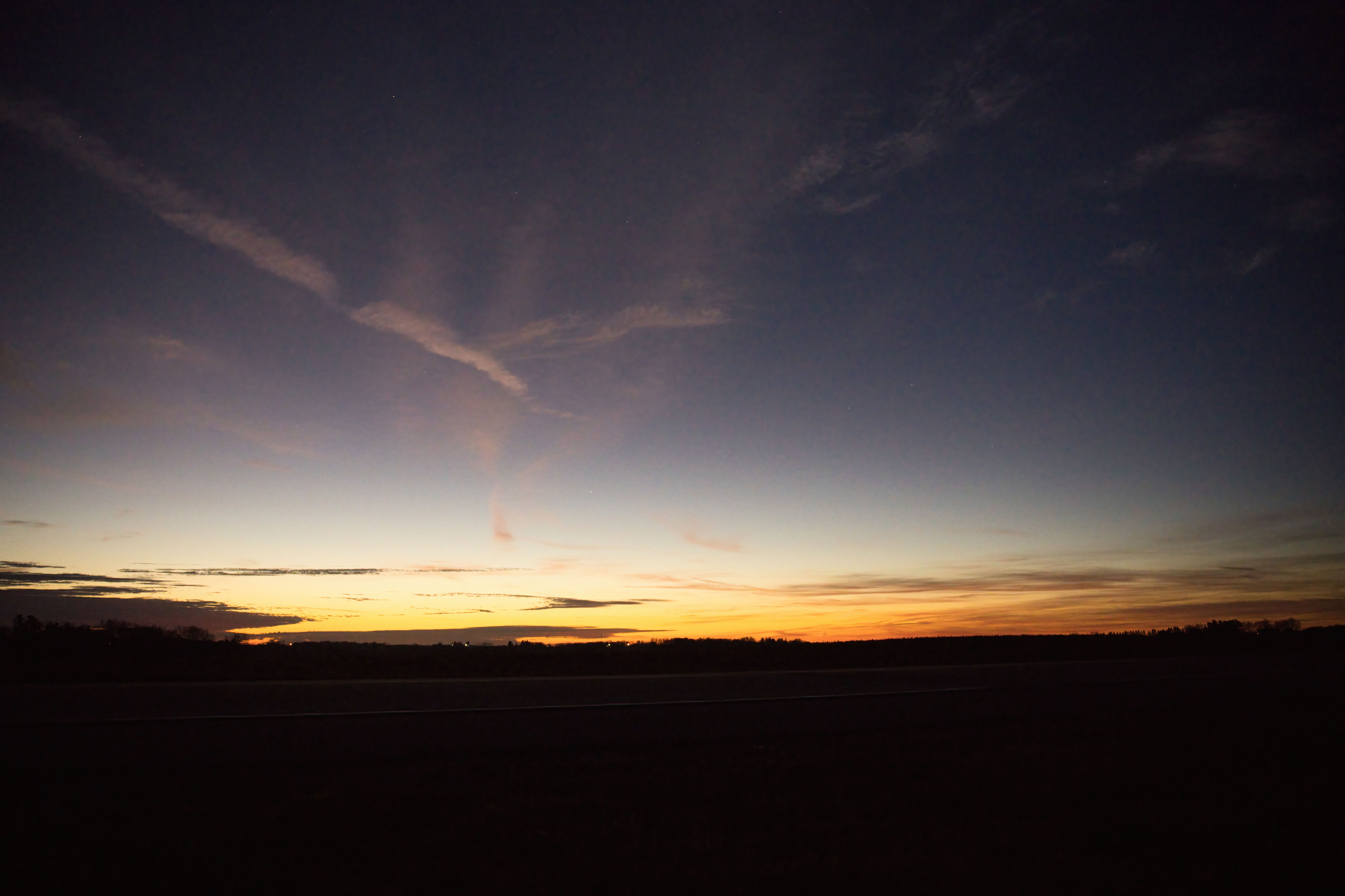 A breathtaking view of the twilight sky over a serene Minnesota landscape.