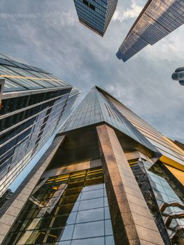 Upward view of New York skyscrapers against a stunning twilight sky, showcasing modern architecture.