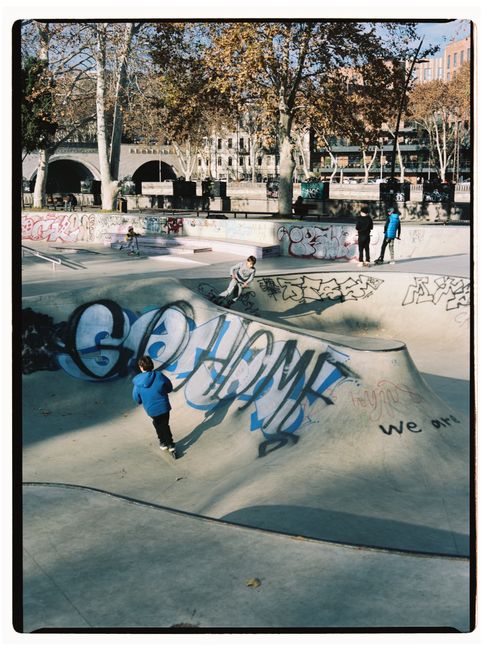 Boys enjoying skateboarding at a graffiti-covered skate park in Tbilisi, Georgia.