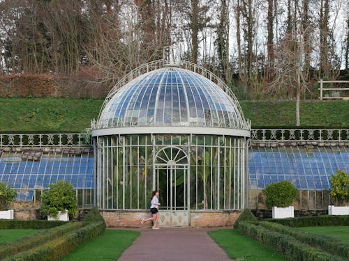 Woman Running near Greenhouse in Park