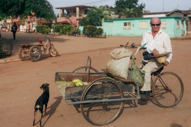 Man Driving Rickshaw Transporting Fruits 