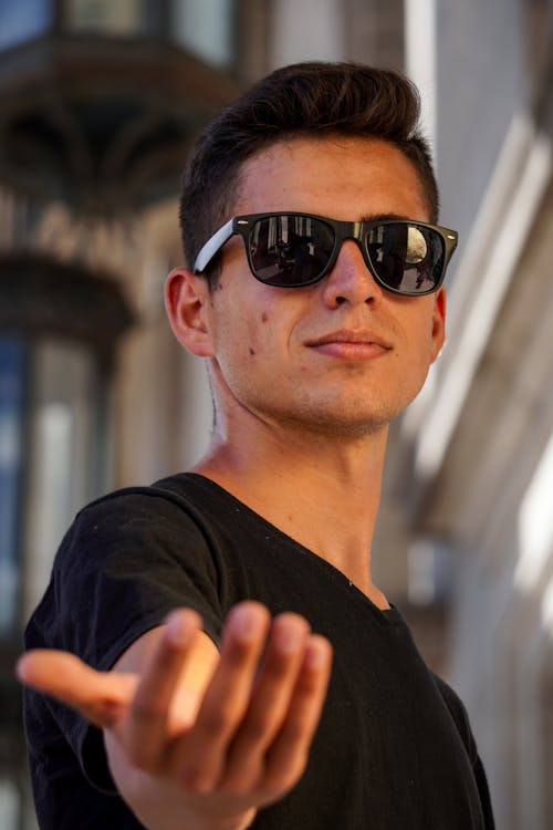 A Man in Black Sunglasses Reaching Out