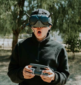 A man enjoying immersive VR gaming outdoors, holding a controller and wearing advanced goggles.