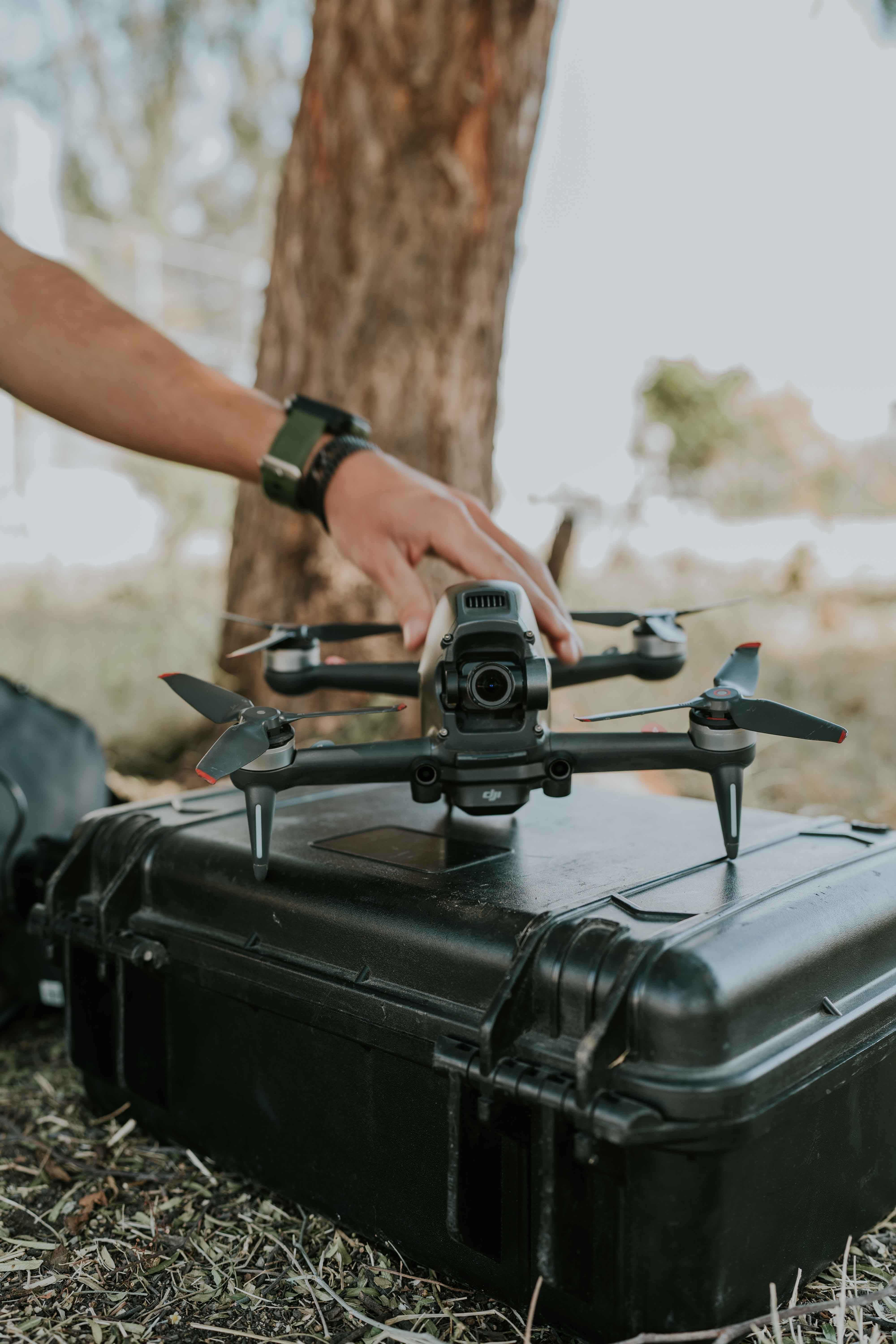 Man Hand on Drone on Box  Free Stock Photo
