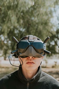 Adult male exploring virtual reality outdoors with advanced goggles.