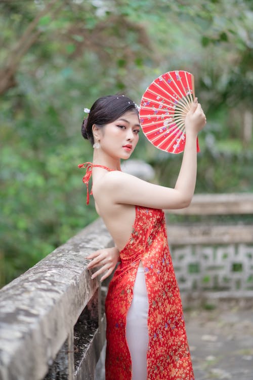 Woman Posing in Red Dress and with Fan