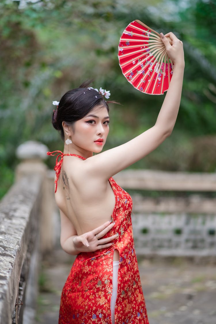 Beautiful Woman Holding A Fan