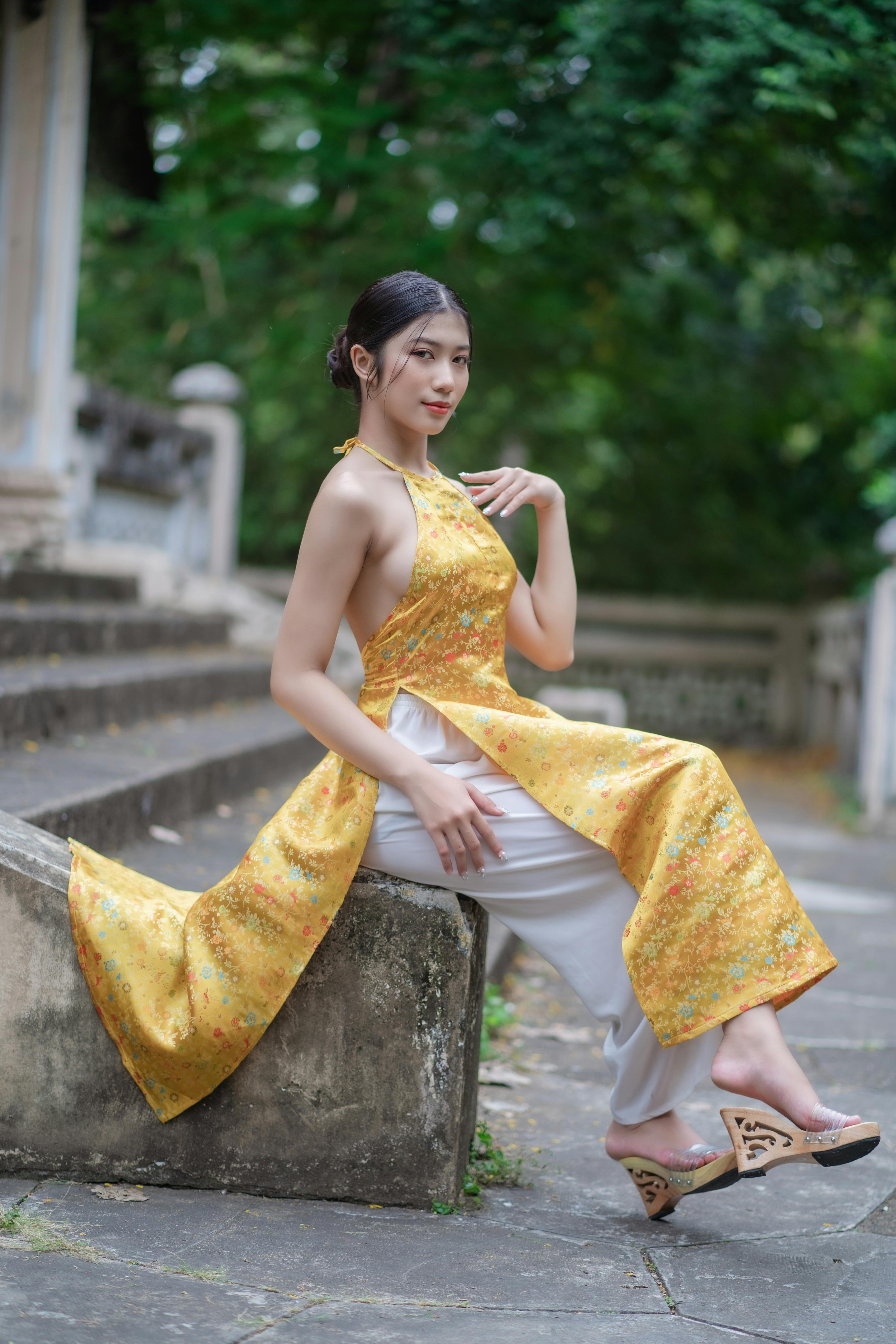 young woman in traditional clothing posing outside