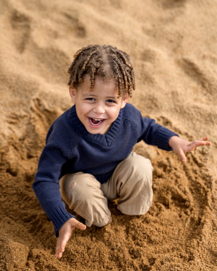 Boy Playing In Sand