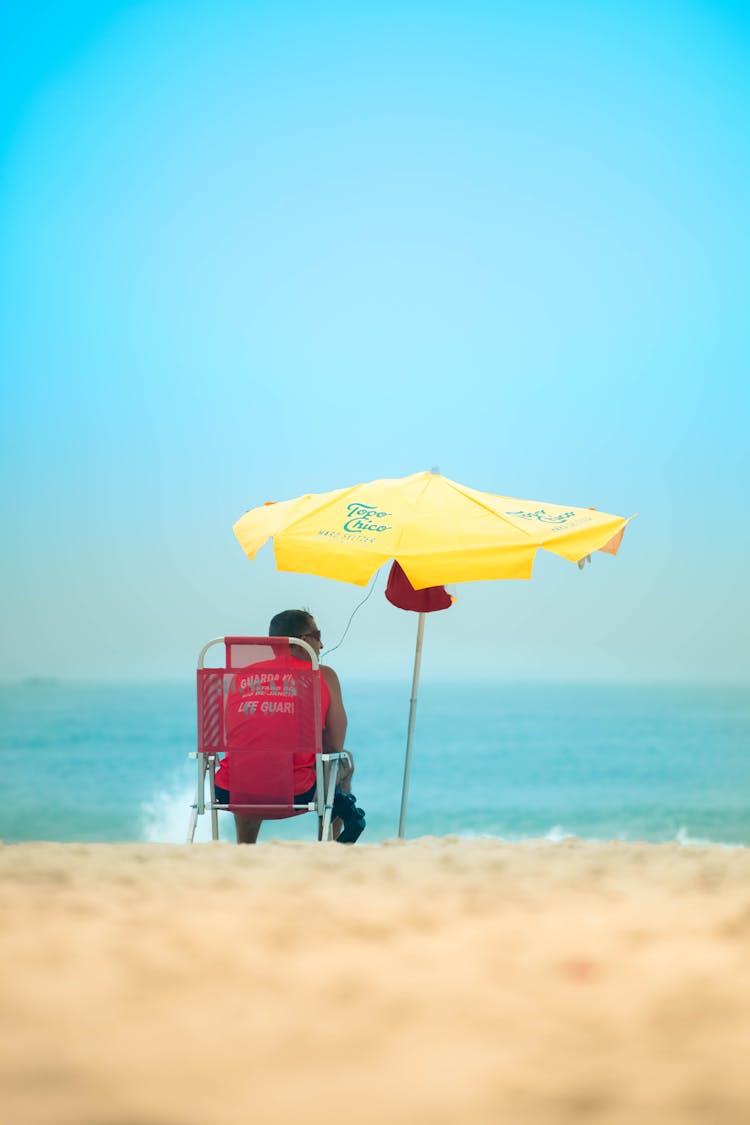 Lifeguard Sitting On The Beach