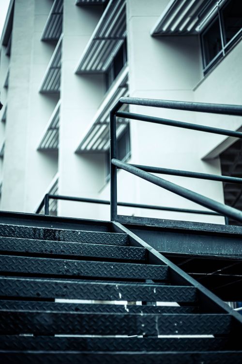 Free Low-angle view of modern building and metal staircase, emphasizing urban architecture. Stock Photo