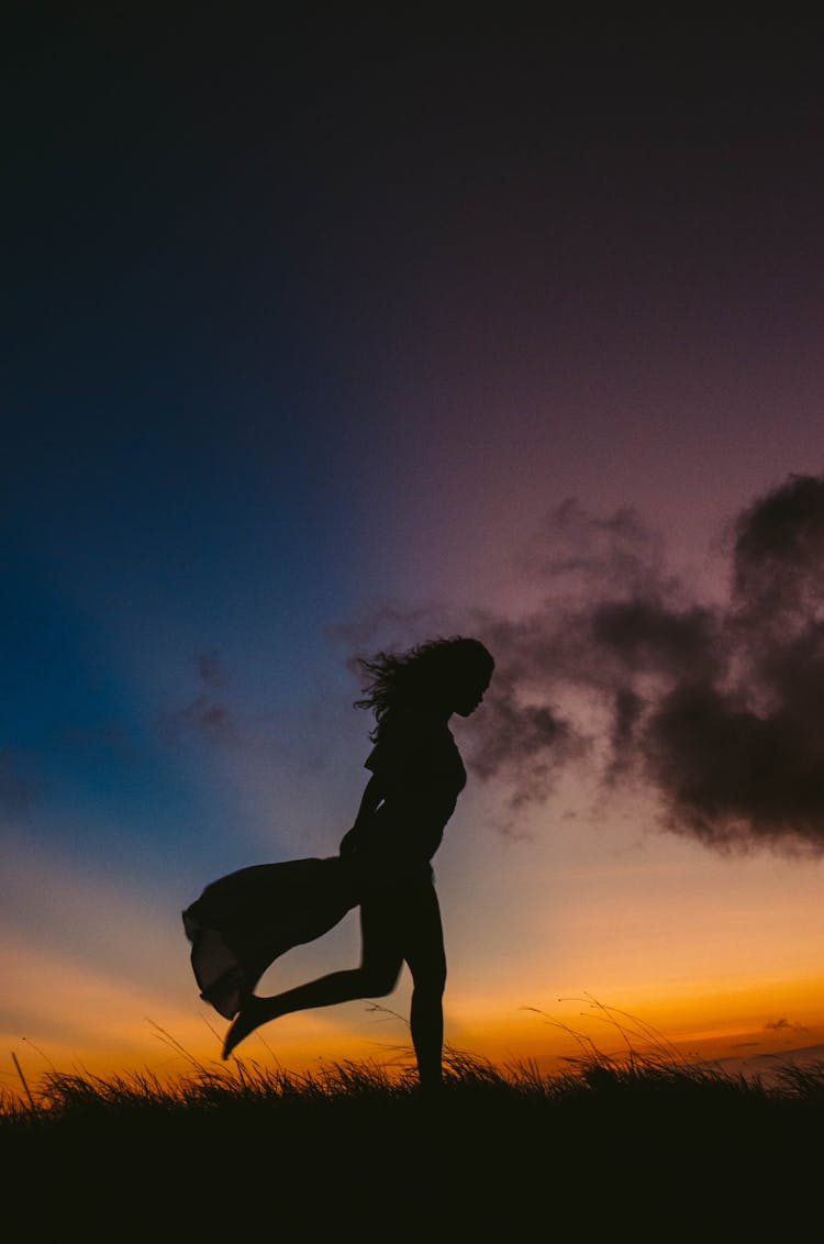 Silhouette Of Running Woman In Dress