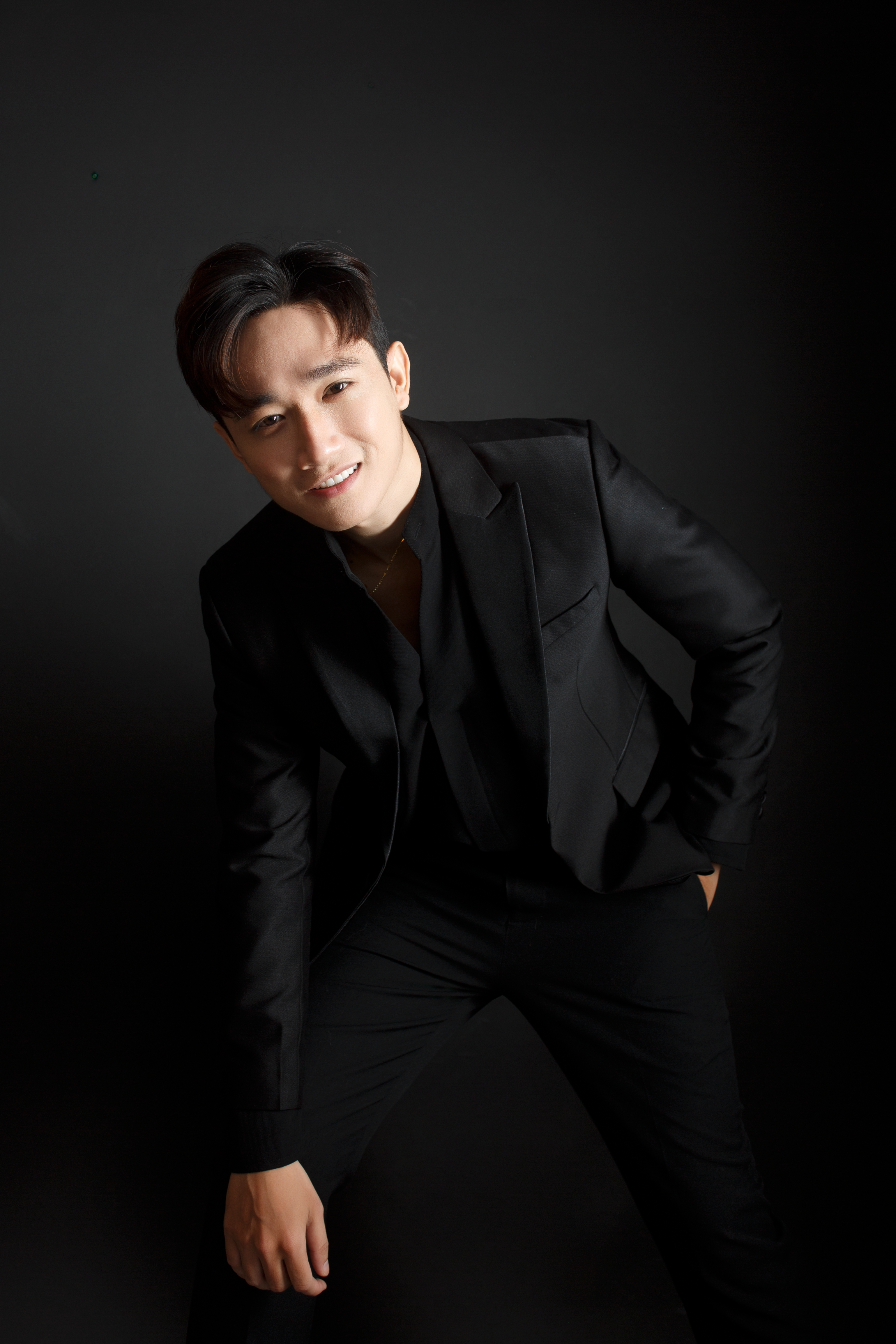 Portrait of a Man Wearing Black Suit on Black Background · Free Stock Photo