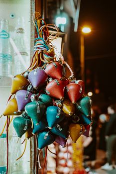 Vibrant night scene in Istanbul showcasing colorful decorations hanging in a street market.