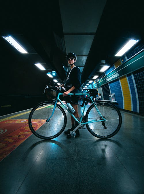 Cyclist with Bicycle on Subway Station