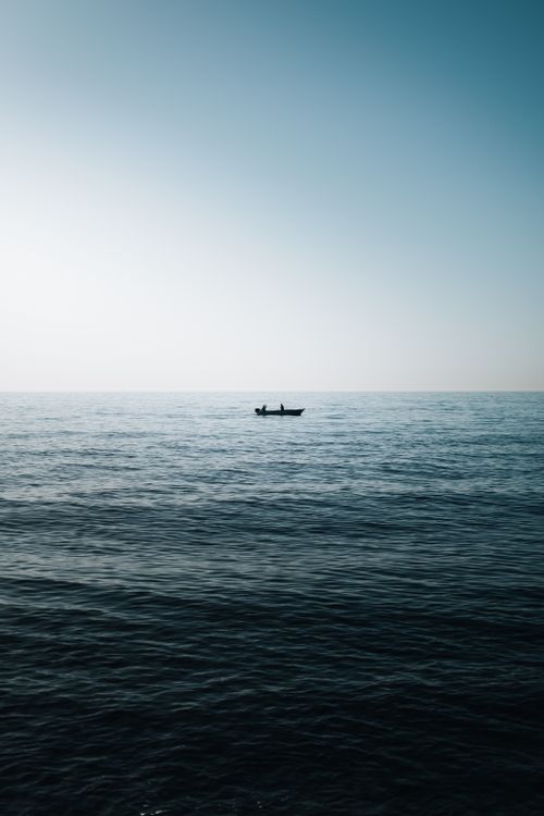 Free A peaceful seascape with a lone boat on the horizon in Adalar, İstanbul. Stock Photo