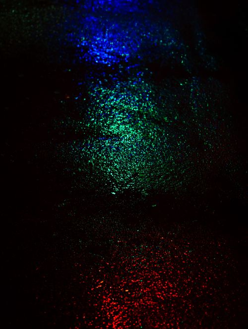 Free Vibrant reflections of lights on wet asphalt create a vivid nighttime street scene. Stock Photo