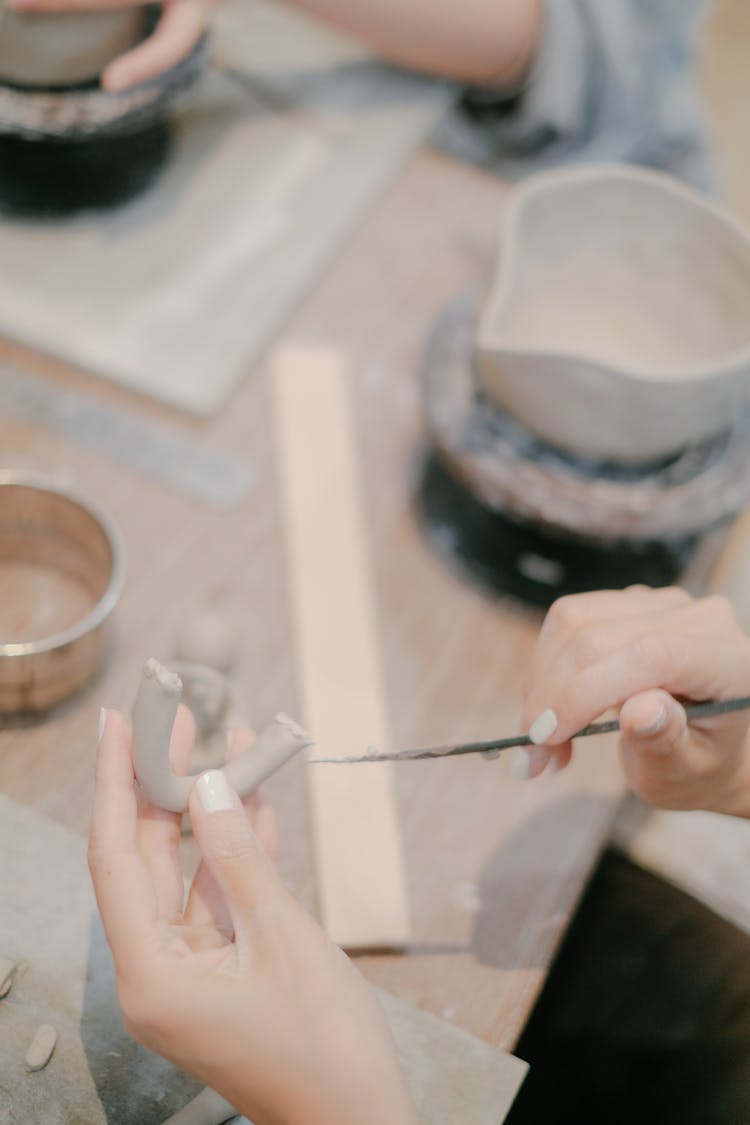 Close Up Of Woman Hands Decorating Item