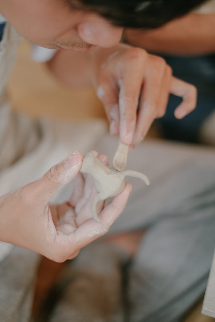 Man Making Clay Figurine