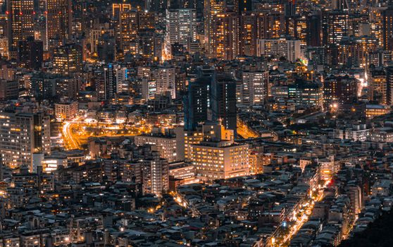 A dazzling cityscape captured at night, showcasing illuminated buildings and bustling streets.