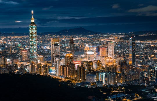 Capture of the illuminated Taipei cityscape showcasing Taipei 101 at night.