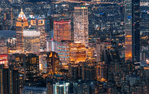 Free A stunning aerial view of illuminated city skyscrapers at night. Stock Photo