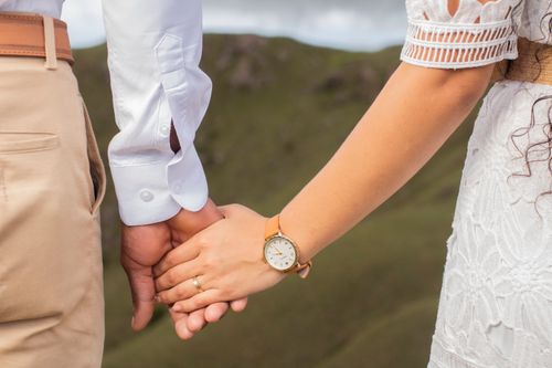 Free A romantic close-up of a couple holding hands outdoors, symbolizing love and connection. Stock Photo