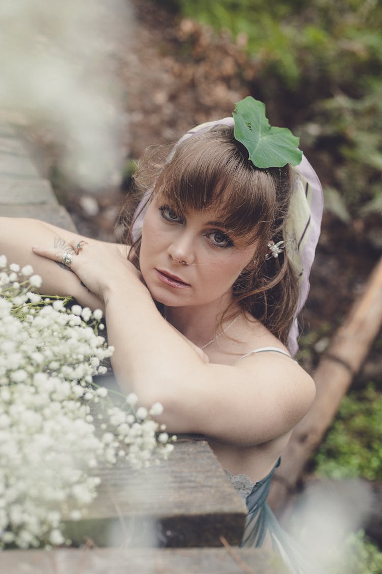 Beautiful Woman With Flowers Posing In Nature