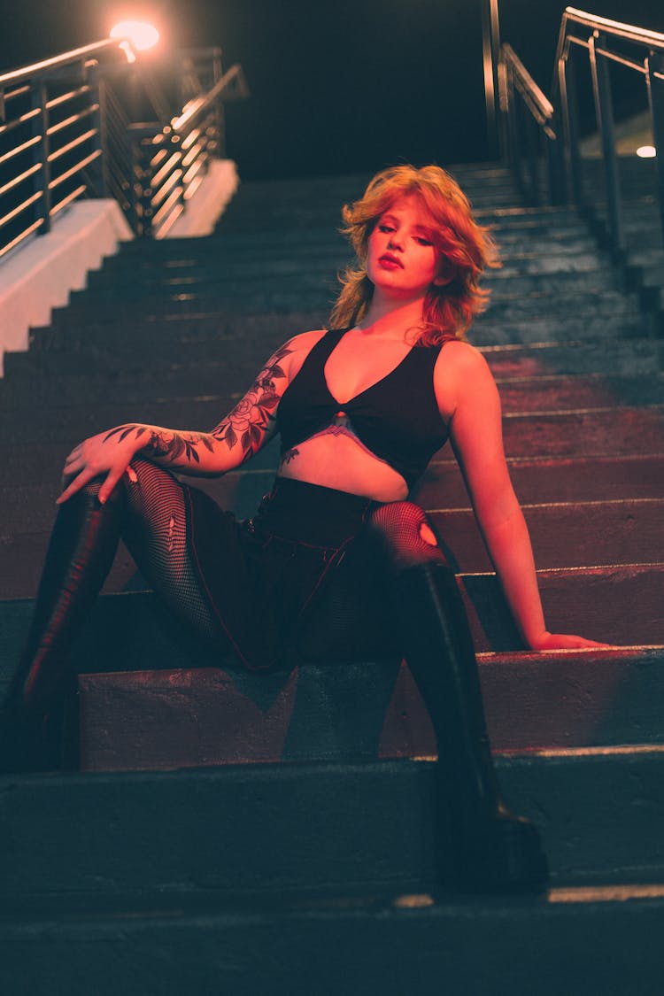 Girl In Sexy Outfit Sitting On Stairs At Night