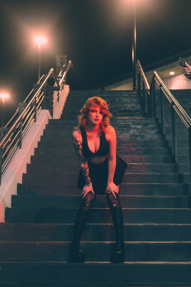 Girl In Sexy Outfit Posing On Stairs At Night