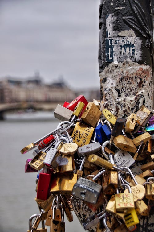 Free Close-up of colorful love locks on a Parisian bridge, symbolizing eternal commitment. Stock Photo