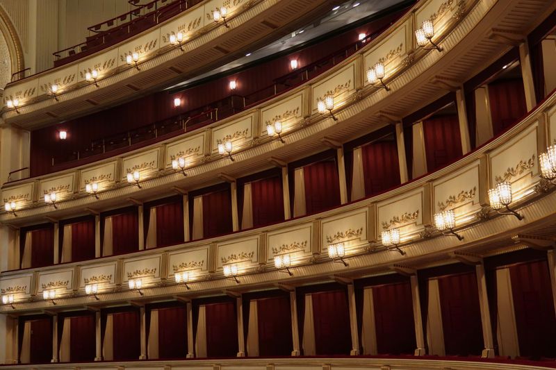 Ornate historic opera house interior with tiered seating and warm lighting