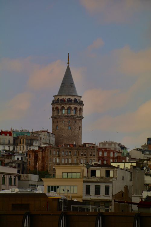 Free Iconic Galata Tower overlooking Istanbul at dusk, with a colorful sky. Stock Photo